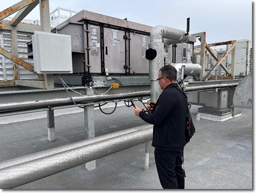 Photo of a maintenance worker testing a power box